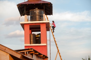 Polly climbing up the water tower in her clogs